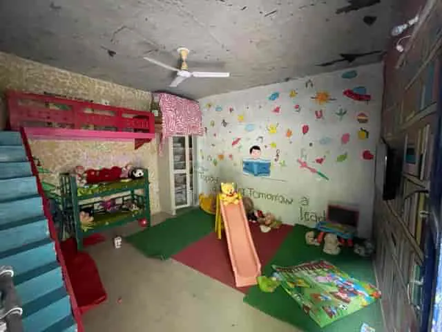 Indoor activity room with slide and play mats