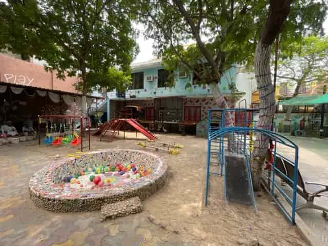 Outdoor play yard with ball pool, slide and climbing frame