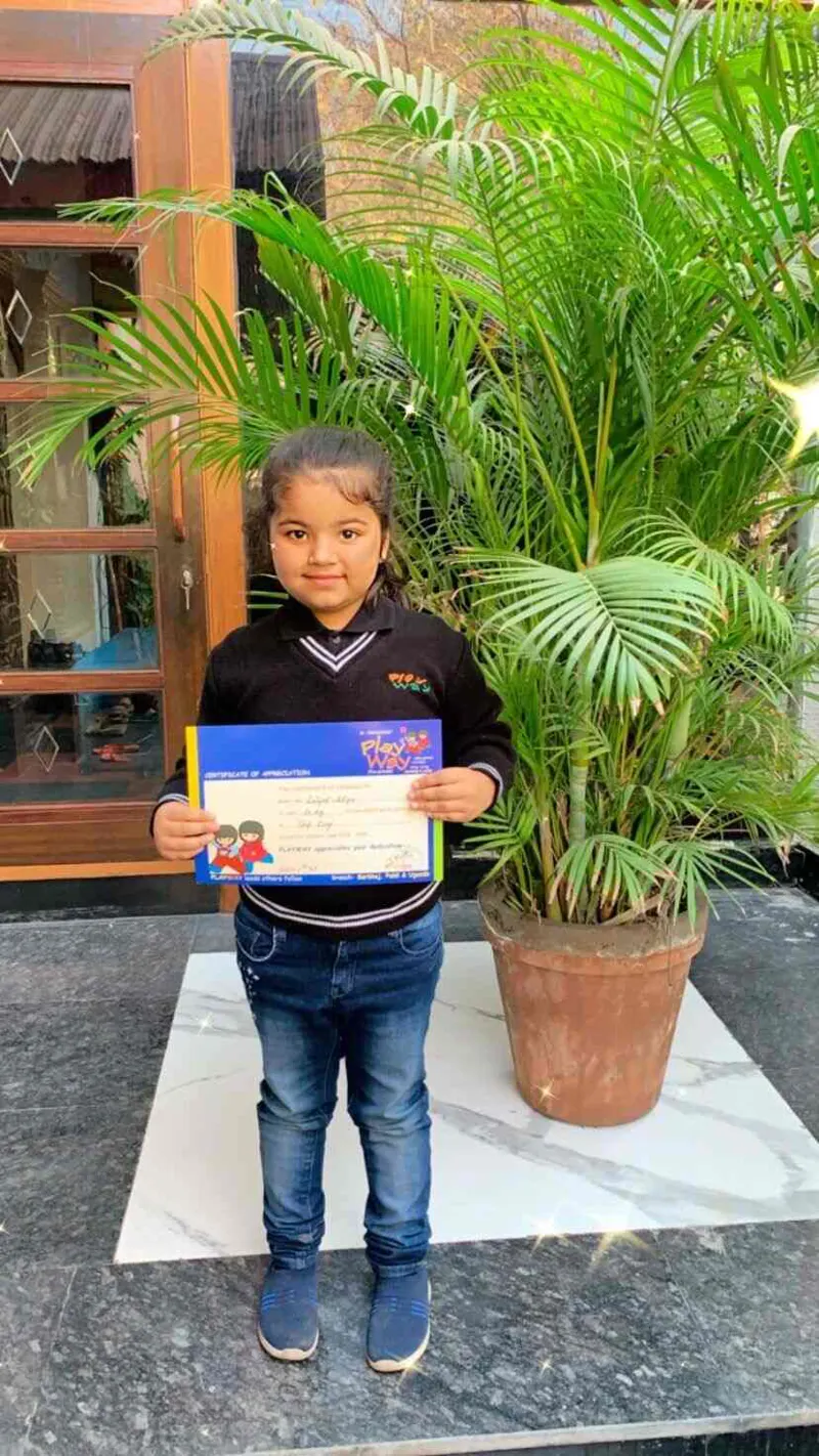 Girl proudly holding her certificate