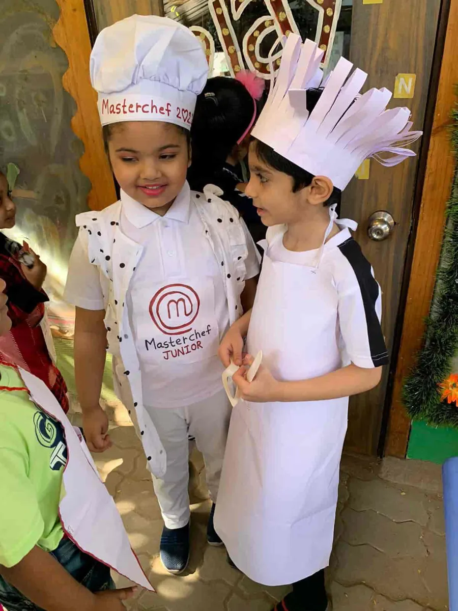 Two little chefs in paper chef hats