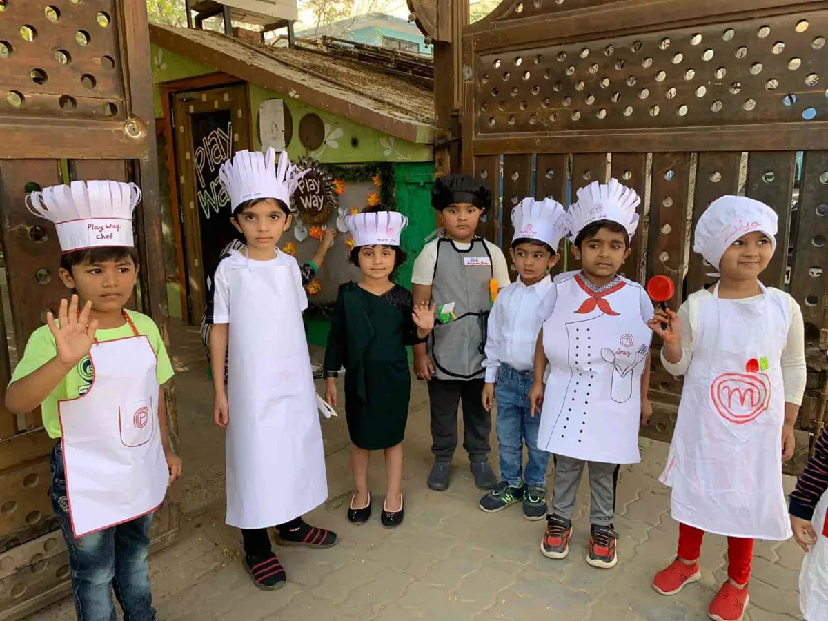 Children in chef hats and aprons on Masterchef Junior day