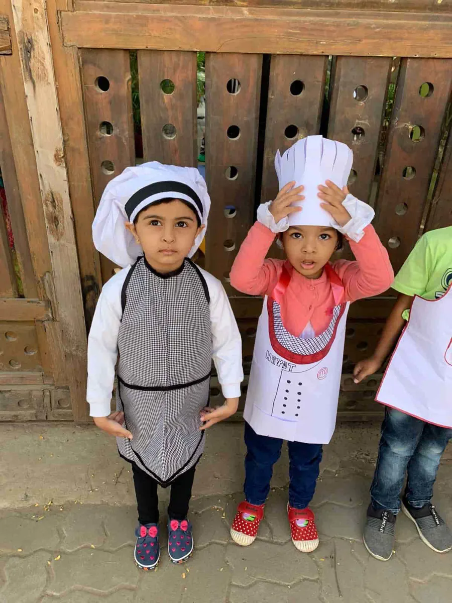 Three children in chef costumes