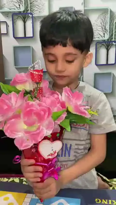 Boy holding a paper flower craft