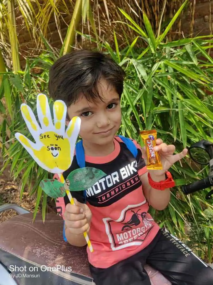 Boy holding his hand-print craft