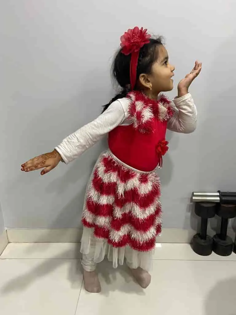 Little girl dancing in a red frock