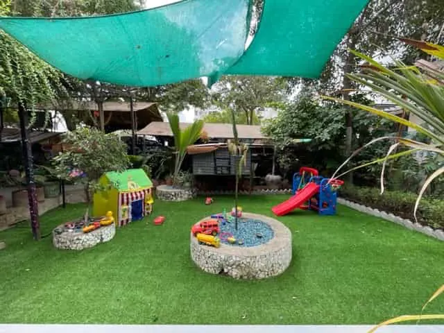 Playway garden with lawn, play house and slide