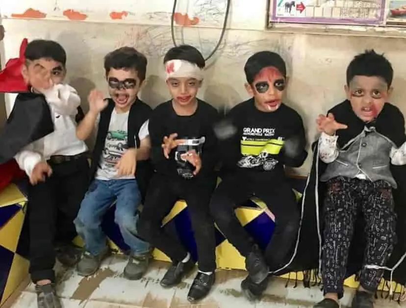 Children in Halloween face paint and costumes