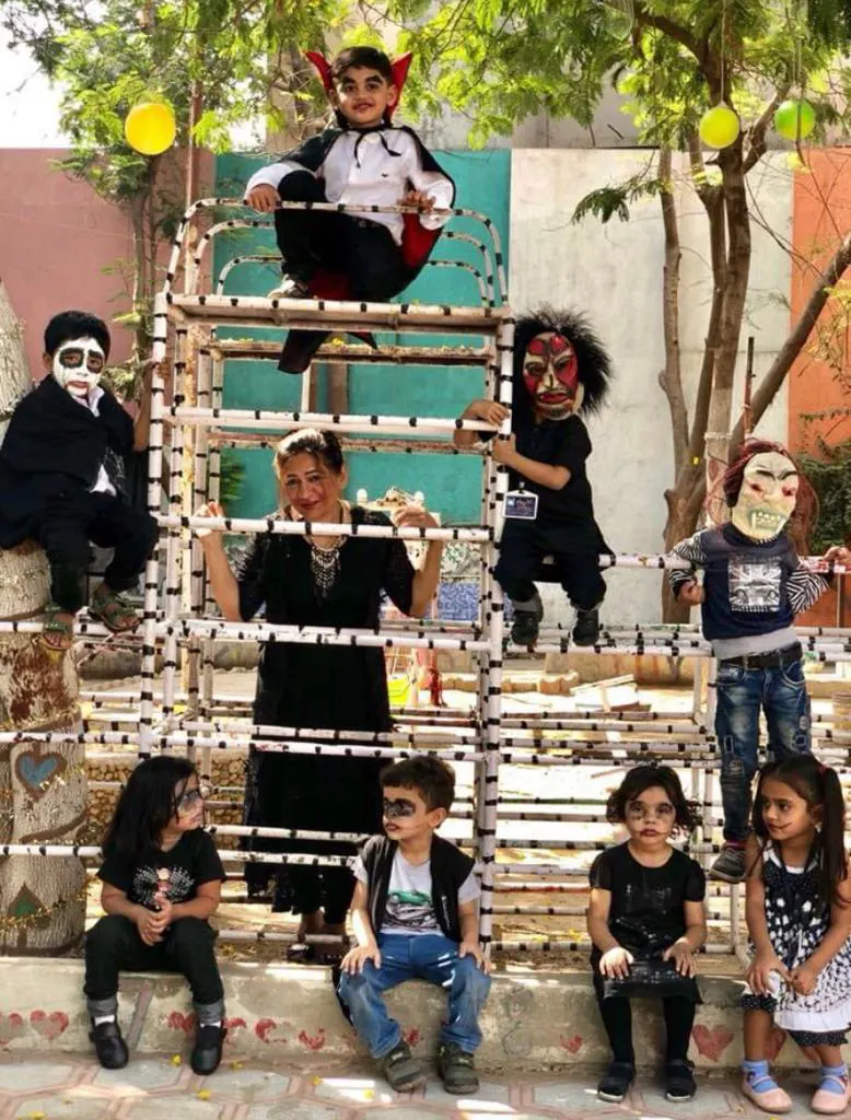 Children in Halloween costumes on the climbing frame