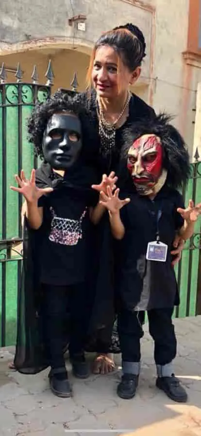 Children in Halloween masks with their teacher
