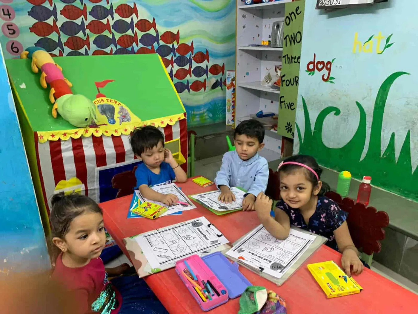 Children busy with a colouring activity in a Playway classroom