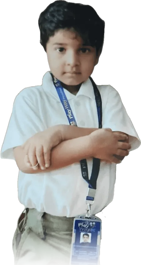 A proud Playway student in school uniform with his Playway ID card