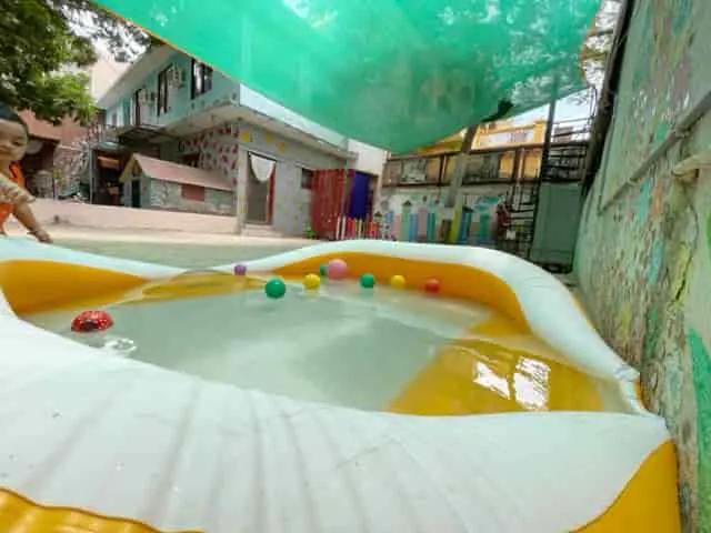 Paddling pool with colourful balls in the school yard